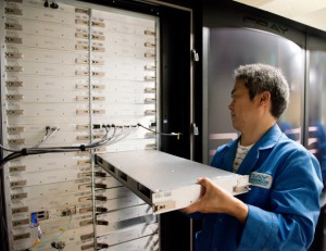 A Cray Japan Inc. engineer exchanging a blade in the ATERUI Cray XC30 supercomputer. In total, 266 blade units for calculations were replaced. Image credit: NAOJ