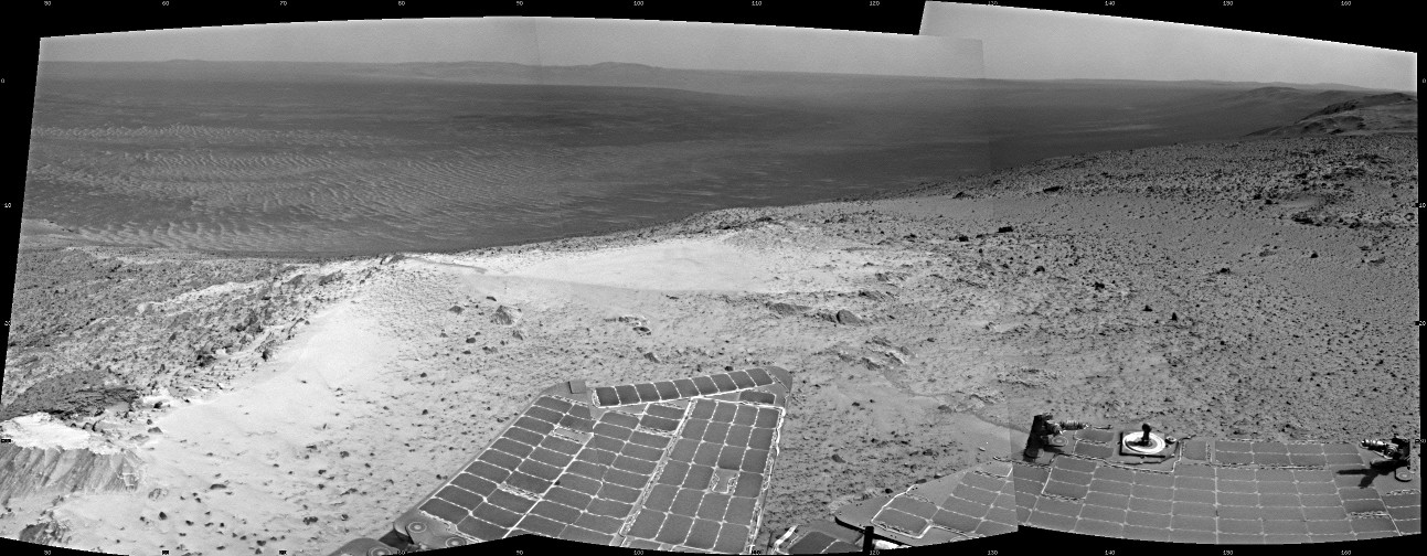 NASA's Mars Exploration Rover Opportunity recorded this view just after reaching the summit of "Cape Tribulation," on the western rim of Endeavour Crater, on 6th January 2015, the 3,894th Martian day, or sol, of the rover's work on Mars. The site is about 440 feet (about 135 metres) higher in elevation than the plain surrounding the crater, higher than any other point Opportunity has reached since it began exploring the Endeavour rim in 2011. This view spans from northeast, at left, to south-southeast, at right. Image credit: NASA/JPL-Caltech