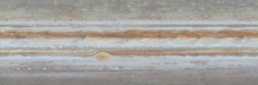 The first colour movie of Jupiter from NASA's Cassini spacecraft shows what it would look like to peel off the entire globe of Jupiter, stretch it out on a wall into the form of a rectangular map, and watch its atmosphere evolve with time. The wide equatorial zone is visible in the centre surrounded by two dark equatorial belts (SEB and NEB). The large grayish-blue irregular "hot spots" at the northern edge of the white Equatorial Zone change over the course of time as they march eastward across the planet. The Great Red Spot is at the southern margin of the SEB. Strings of small storms rotate around northern-hemisphere ovals. Small, very bright features, possible lightning storms, appear quickly and randomly in turbulent regions. The smallest features visible at the equator are about 600 kilometres across. This 14-frame animation spans 24 Jovian days, or about 10 Earth days. The passage of time is accelerated by a factor of 600,000. Image credit: NASA/JPL/University of Arizona