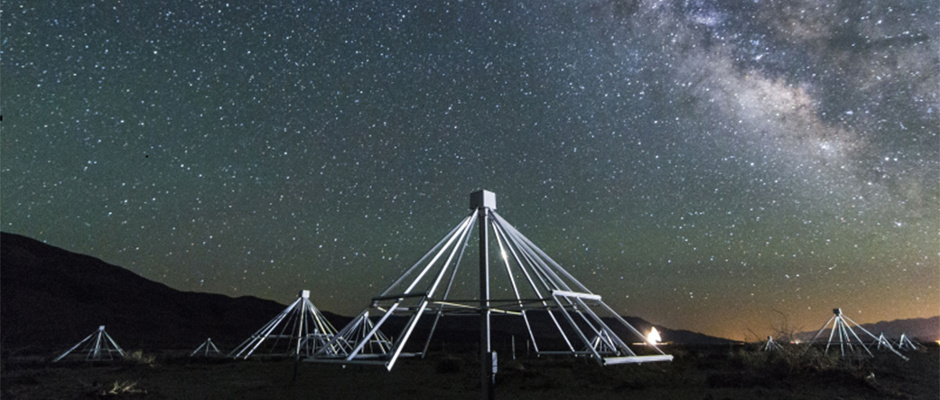 A nighttime shot shows some of the antennas of the Owens Valley Long Wavelength Array in California, with the centre of our galaxy in the background. Image credit: Gregg Hallinan.