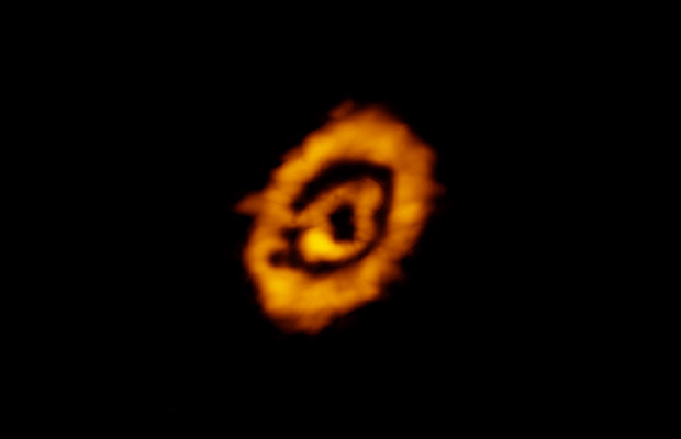 Atacama Large Millimeter/submillimetre Array (ALMA) image of dual rings of DCO+ encircling the star IM Lup. The rings reveal details about the conditions of this young protoplanetary disc. The existence of the outer ring was surprising, providing new insights into the formation of heavy molecules — those based on deuterium — in this and other similar systems. Image credit: K. Oberg, CfA, et al.; ALMA (NRAO/ESO/NAOJ); B. Saxton (NRAO/AUI/NSF).