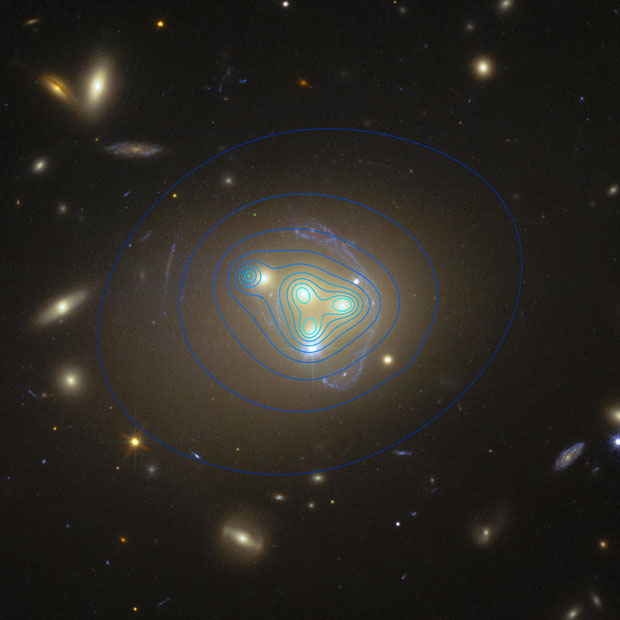 The merger of four galaxies in the Abell 3827 cluster. The blue contour lines indicate the density of the dark matter clumps around them, and the clump for the galaxy on the left is lagging behind it. Image: ESO/R Massey.