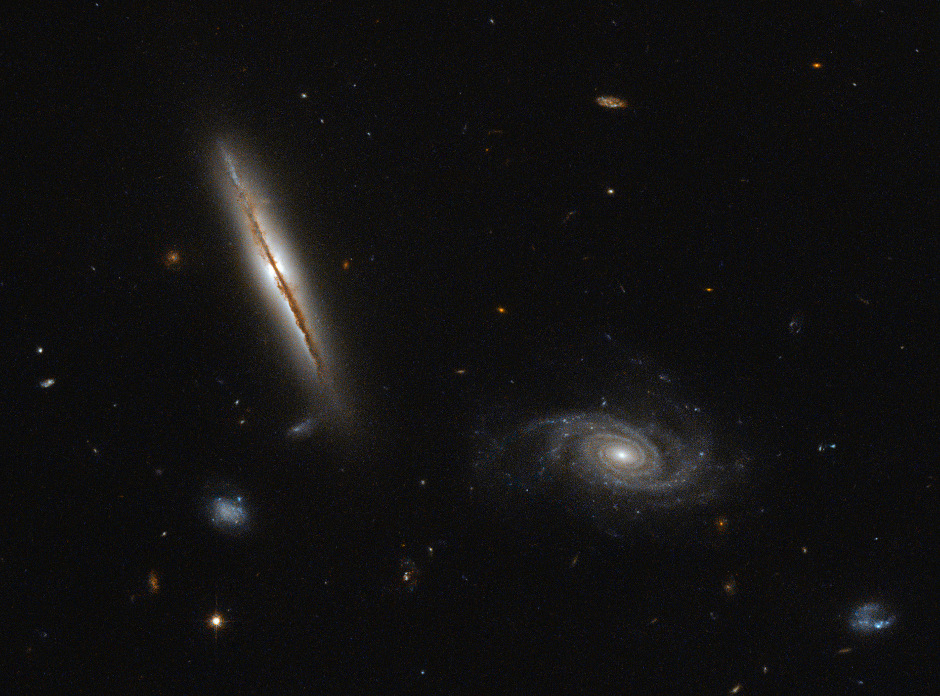 LO95 0313-192 is the large, edge-on spiral galaxy left of centre in this image. It lies about one billion light-years away in the constellation of Eridanus. In 2003, the galaxy was discovered to possess giant jets of superheated gas emitting in the radio part of the spectrum. These jets have long been associated with the cores of giant elliptical galaxies, but rare in spirals. Image credit: ESA/Hubble & NASA. Acknowledgement: Judy Schmidt.