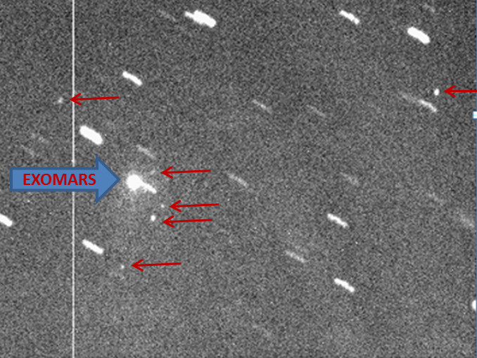 In this 14 March image from the Observatório Astronômico do Sertão de Itaparica in Brazil, the ExoMars spacecraft appears as a bright object surrounded by at least six other fainter spots (highlighted by red arrows) — elements of the Proton launch rocket’s discarded upper stage — moving together in the sky. Image credit: OASI Observatory team; D. Lazzaro, S. Silva.