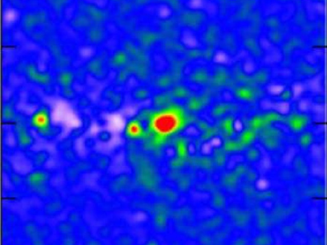 A false-colour image of the anomalous gamma-ray emission from the central region of the Milky Way galaxy; this emission is suspected of coming from dark matter annihilation. In this image, the emission from conventional sources has been subtracted from the total. The region covers roughly five degrees; the brightest emission is coloured red and faintest blue. Image credit: Daylan et al.