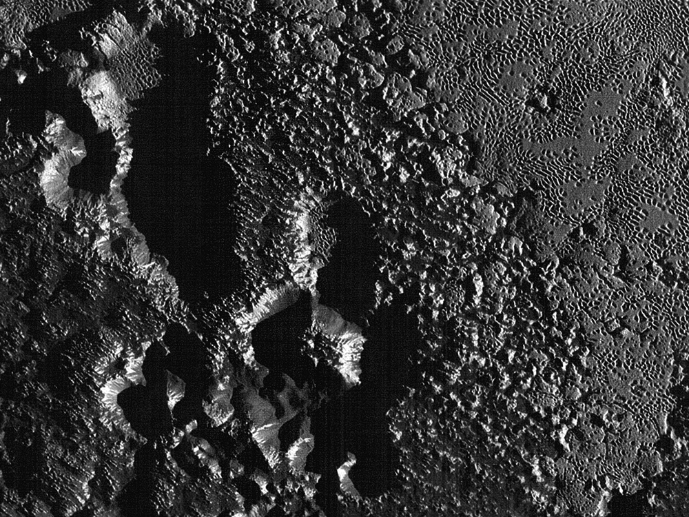 The rugged dark highlands of Pluto as revealed by NASA's New Horizons spacecraft  at 80 metres (260 feet) per pixel during its close flyby of 14 July 2015. Click the image to see the full mosaic strip. Image credit: NASA/JHUAPL/SwRI.