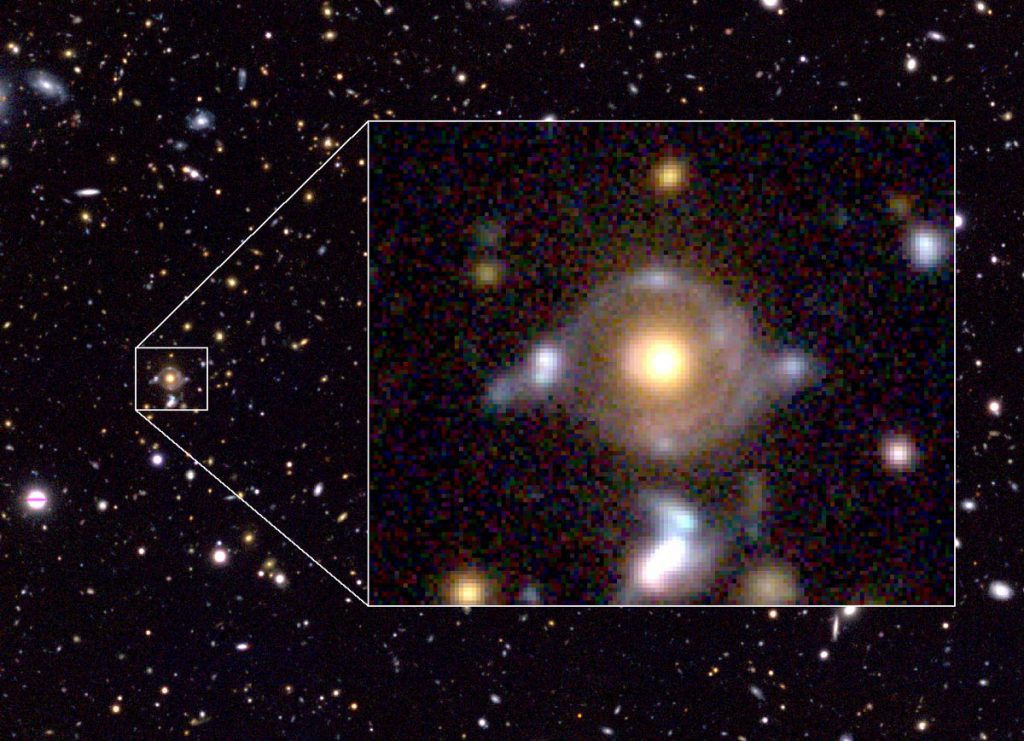 Eye of Horus in pseudo colour. Enlarged image to the right (field of view of 23 arcseconds x 19 arcseconds) show two arcs/rings with different colours. The inner arc has a reddish hue, while the outer arc has a blue tint. These arcs are lensed images of the two background galaxies. There are blobs in and around the arcs/rings, which are also the lensed images of those background galaxies. The yellow-ish object at the centre is a massive galaxy at a distance 7 billion light years, which bends the light from the two background galaxies. 