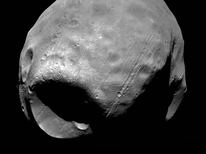 Lawrence Livermore National Laboratory researchers have demonstrated for the first time how an asteroid or comet could have caused the mega crater known as Stickney on Phobos without completely destroying the Martian moon. Image credit: NASA/LLNL.