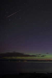 A bright Perseid streaks across a starry sky.